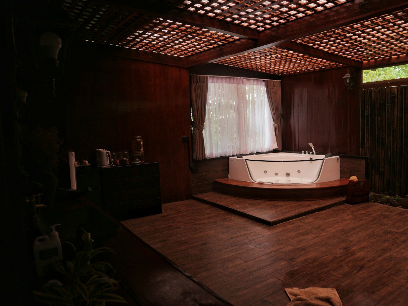 A private jacuzzi suite at Piano Spa, panelled in dark timber and lit low